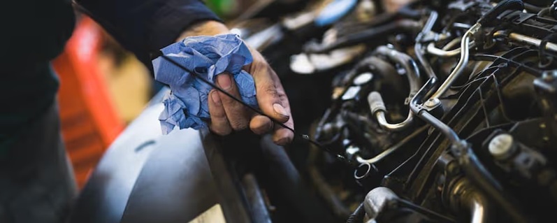 mechanic pouring oil